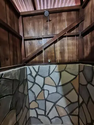 a room with wooden walls and a stairway with a stained glass at Cabaña del Bosque in Tapantí