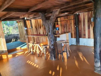 a room with a tree inside of a house at Cabaña del Bosque in Tapantí