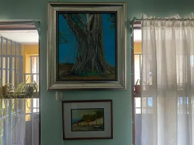 a painting of a tree hanging on a wall at Close to Walmart supermarket chain in San Pablo