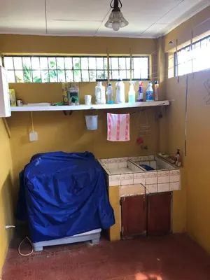 a small kitchen with a blue tarp on the counter at Close to Walmart supermarket chain in San Pablo