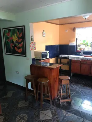 a kitchen with two stools and a counter with a microwave at Close to Walmart supermarket chain in San Pablo