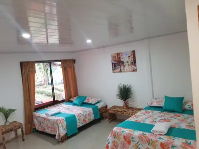 a bedroom with two beds and a window at Hotel Maguey in Chilamate
