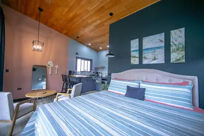 a bedroom with a large bed and a table and chairs at Refugio Turquesa-Luxury King Suite with Private Jacuzzi Balcony-5 min to La Fortuna in Fortuna