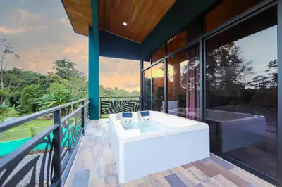 a bathroom with a white tub on a balcony at Refugio Turquesa-Luxury King Suite with Private Jacuzzi Balcony-5 min to La Fortuna in Fortuna