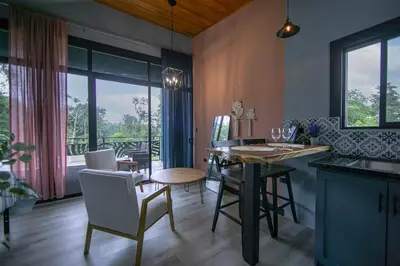 a kitchen with a table and chairs and a dining room at Refugio Turquesa-Luxury King Suite with Private Jacuzzi Balcony-5 min to La Fortuna in Fortuna