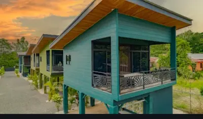 a blue house with a balcony with zebras on it at Refugio Turquesa-Luxury King Suite with Private Jacuzzi Balcony-5 min to La Fortuna in Fortuna