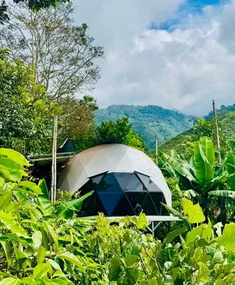 a white tent in the middle of a field at Kayala Dome - Private luxury Dome in La Ese