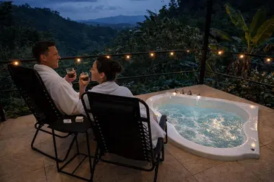 a man and woman sitting in chairs next to a tub at Kayala Dome - Private luxury Dome in La Ese
