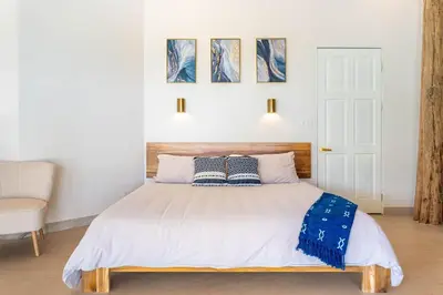 a bedroom with a bed with two pillows on it at Eco-Luxurious Villa 4bdr - 5 min to the Beach in Uvita