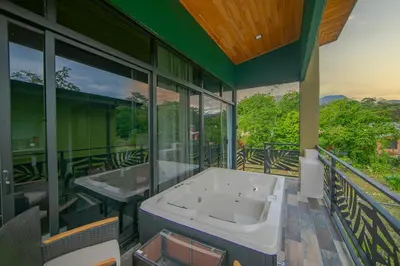 a large bathroom with two tubs on a balcony at Paraiso Lima -Luxury King Suite with Private Jacuzzi Balcony-5 min to La Fortuna in Fortuna