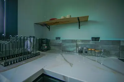 a kitchen with a white counter top and a shelf at Paraiso Lima -Luxury King Suite with Private Jacuzzi Balcony-5 min to La Fortuna in Fortuna