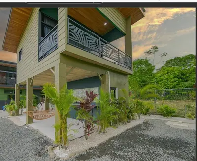 a building with a balcony with plants in front of it at Paraiso Lima -Luxury King Suite with Private Jacuzzi Balcony-5 min to La Fortuna in Fortuna