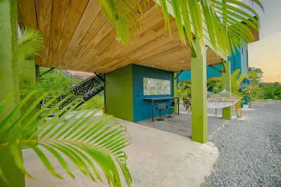 a house with a table and a wooden roof at Refugio Verdanza-Luxury King Suite with Private Jacuzzi Balcony-5 min to La Fortuna in Fortuna