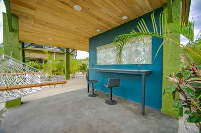 a blue wall with a desk and a chair at Refugio Verdanza-Luxury King Suite with Private Jacuzzi Balcony-5 min to La Fortuna in Fortuna