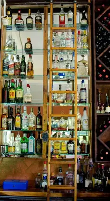 a refrigerator filled with lots of bottles of alcohol at Gingerbread Restaurant & Hotel in Nuevo Arenal