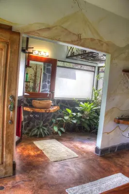 an inside view of a room with plants at Gingerbread Restaurant & Hotel in Nuevo Arenal