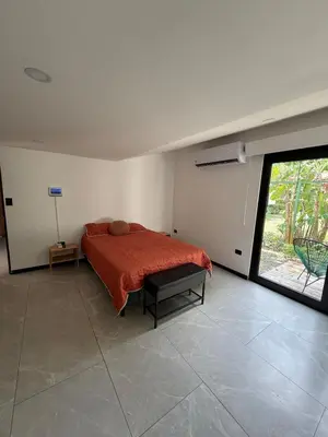 a bedroom with a bed and a large window at Casa Santoni in Quebrada Ganado