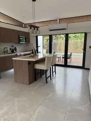 a kitchen with a table and chairs in a room at Casa Santoni in Quebrada Ganado
