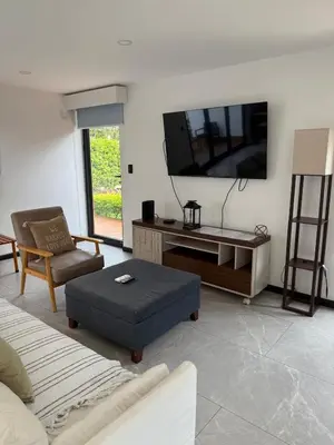 a living room with a flat screen tv on the wall at Casa Santoni in Quebrada Ganado