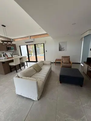 a large living room with a couch and a table at Casa Santoni in Quebrada Ganado