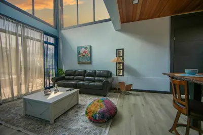 a living room with a couch and a table at La Azulada-5min La Fortuna, King beds, pool, BBQ in Fortuna