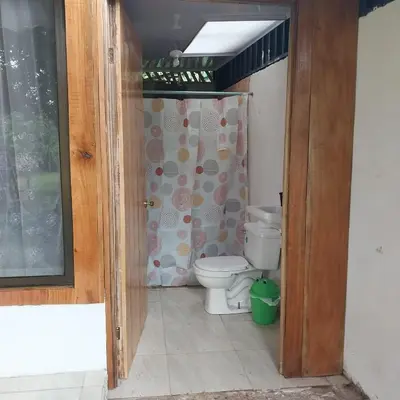 a bathroom with a toilet and a shower at Cabaña Gerya in Chachagua