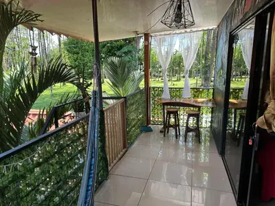 a screened in porch with a table and chairs at Arrecife in Tapantí