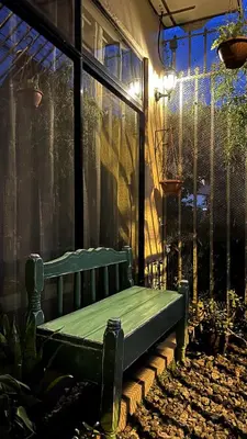 a green bench sitting in the middle of a patio at Casita Vintage AC in Turrialba