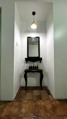 a room with a table and a mirror on a wall at Casita Vintage AC in Turrialba