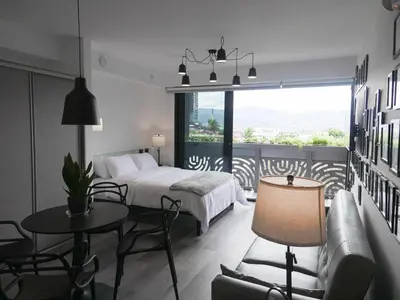 a hotel room with a bed and a table and chairs at Ser Escalante Modern Studio AC in San José