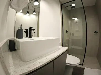 a bathroom with a sink and a toilet and a shower at Ser Escalante Modern Studio AC in San José