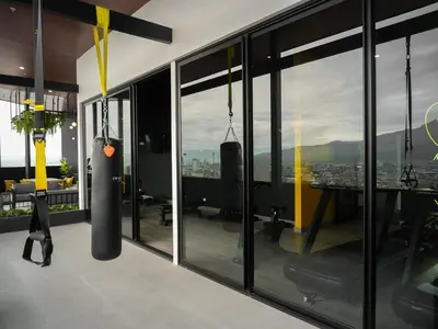 an office with a view of the city through windows at Ser Escalante Modern Studio AC in San José