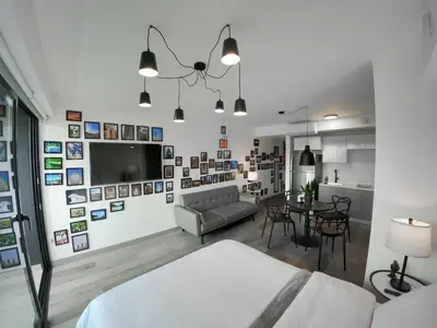 a living room with a couch and a table at Ser Escalante Modern Studio AC in San José