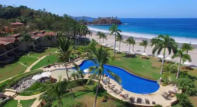 an aerial view of the resort and the beach at Apartment located in The Palms Private in Playa Flamingo, Costa Rica in Portegolpe