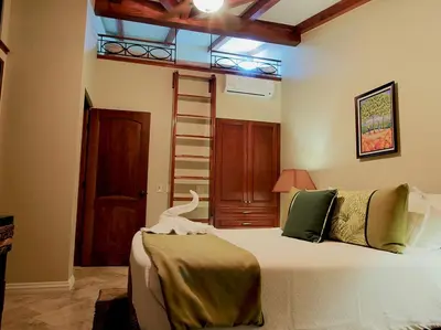 a bedroom with a large bed in a room at Apartment located in The Palms Private in Playa Flamingo, Costa Rica in Portegolpe