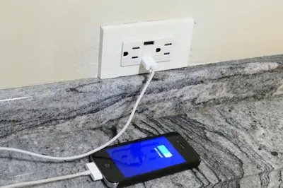 a cell phone hooked up to a light switch at Apartment located in The Palms Private in Playa Flamingo, Costa Rica in Portegolpe