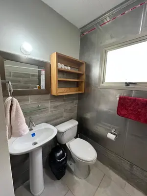 a bathroom with a white toilet and a sink at Pura Vida Jungle Retreat - Montezuma in Montezuma