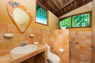 a bathroom with a sink and a mirror at Laguna Lodge Full Board in Tortuguero