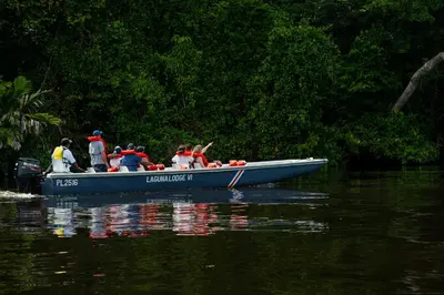 a group of people in a boat on the water at Laguna Lodge Full Board in Tortuguero
