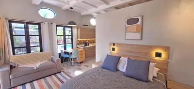 a bedroom with a bed and a desk at Club Heasa - Men Only in La Garita