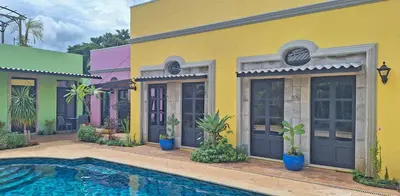 a yellow house with a swimming pool in front of it at Club Heasa - Men Only in La Garita