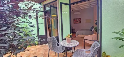 a balcony with a table and chairs and a bedroom at Club Heasa - Men Only in La Garita