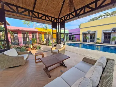 an outdoor living room with a table and a pool at Club Heasa - Men Only in La Garita