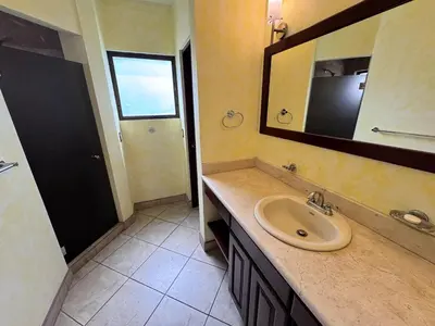 a bathroom with a sink and a mirror at Juanderlust - 2 Bedroom Condo in Tamarindo