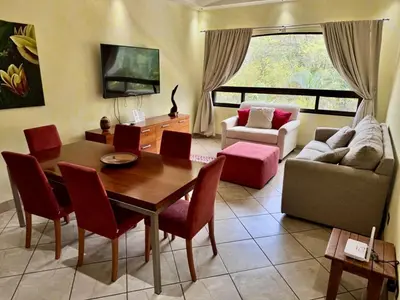 a living room with a table and a couch at Juanderlust - 2 Bedroom Condo in Tamarindo