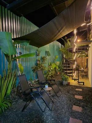 two chairs sitting in a patio with plants at La Casa de Pepa y Poli with Jacuzzi and free bikes in Uvita