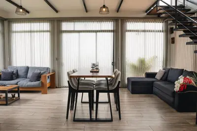 a living room with a table and a couch at Loft con hermosas vistas y Volcán Turrialba in Turrialba