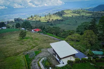 an aerial view of a barn on a hill at Loft con hermosas vistas y Volcán Turrialba in Turrialba