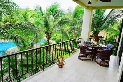 a balcony with a table and chairs and a pool at Luxurious Pacifico 2bed condo in Playa Coco in Coco