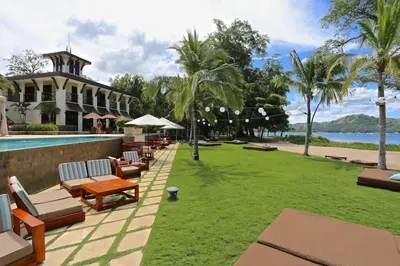 a resort with a pool and chairs and a resort at Luxurious Pacifico 2bed condo in Playa Coco in Coco